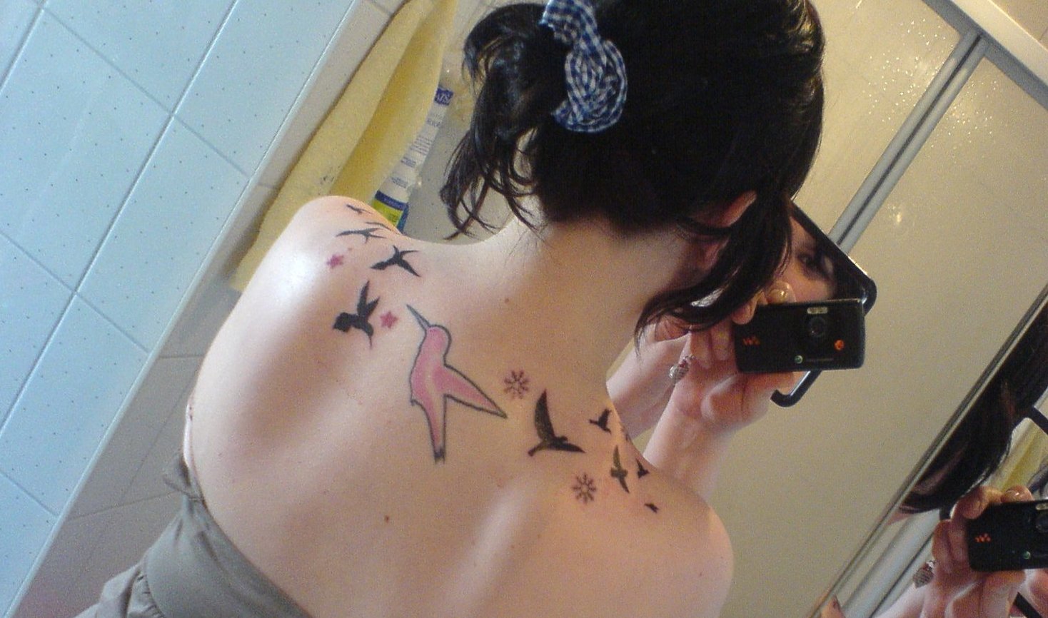 Porn star tattoo birds on back shoulder